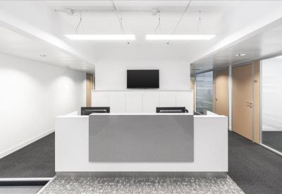 Sleek white and grey reception desk in a brightly lit professional lobby.