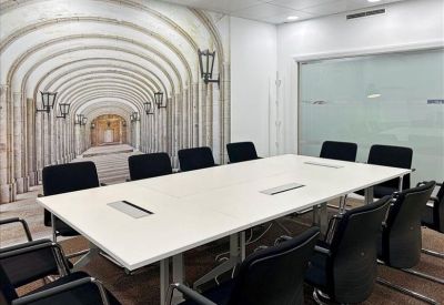 Modern reception lobby with a light wood desk and large windows.