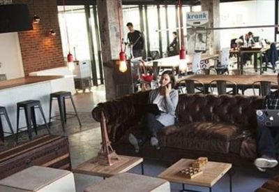 Private office suite with two white desks and large windows overlooking a terrace.