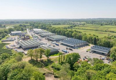 Wide-angle aerial shot of the business park surrounded by green countryside.