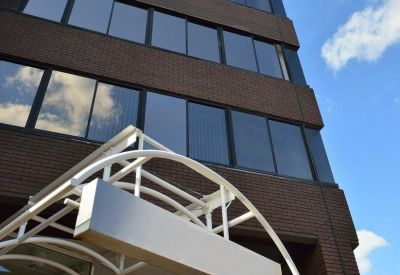 Low angle view of the brick exterior and modern glass entrance of Charter House.