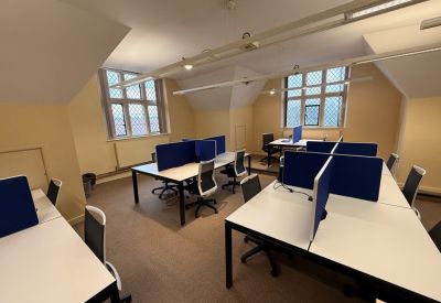 Workspace with multiple desks and traditional leaded glass windows