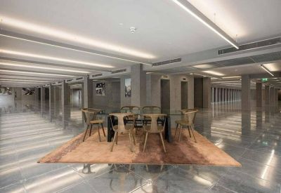 Ultra-modern reflective lobby with sleek lighting and a central dining table.