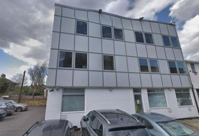 Close-up of the metal-panelled building facade with various windows.