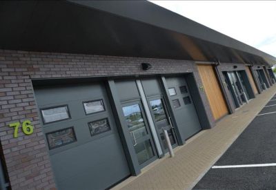 Modern unit entrance with brick facade and dark grey loading doors.