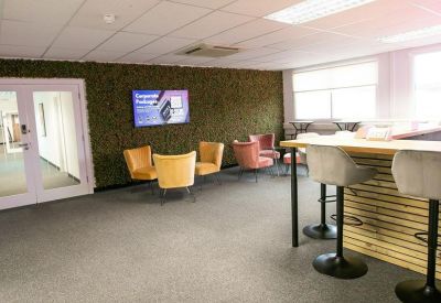 Spacious communal lounge at The Hub, Suite 10, Cringleford Business Park, featuring a breakfast bar and green moss wall.