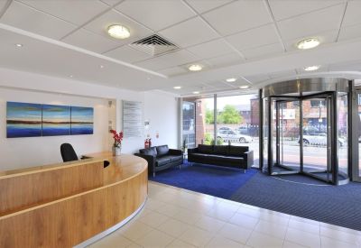 Modern lobby and wooden reception desk at Crossgate House, Cross Street, Manchester.