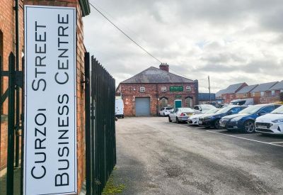 Entrance signage and gated parking area.