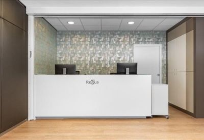 Clean white reception desk set against a patterned feature wall.