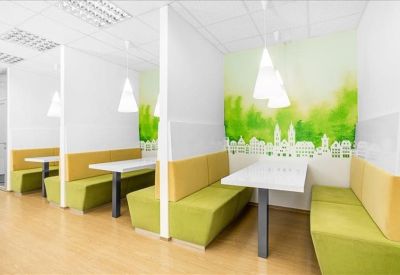 Modern breakout booths with lime green seating and pendant lighting.