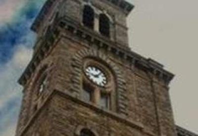 Exterior view of the historic stone clock tower building at Dalton Lane, Keighley, West Yorkshire.