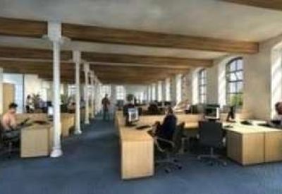 Modern office workspace featuring wooden beams, white pillars, and rows of desks.