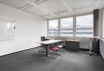 Internal private office suite featuring a height-adjustable desk and whiteboard.
