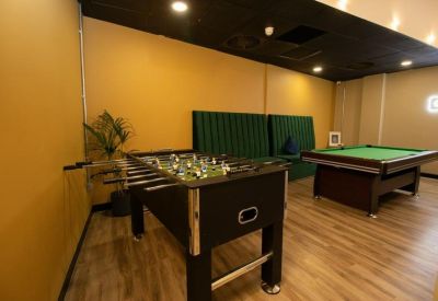 Professional boardroom with a long dark wood table and elegant chandeliers.