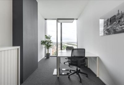 Private windowed office suite with two desks and a potted plant.