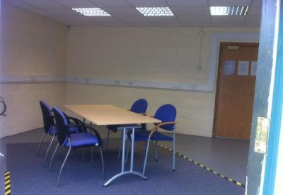 Small meeting room with a table and five chairs.