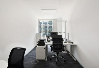 Private office with desks and city view.