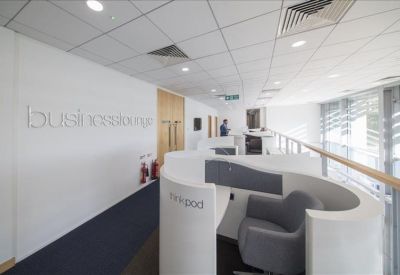 Modern business lounge with private semi-circular workspace pods and balcony.