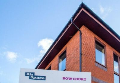 Close-up of the brick building facade with Bow Court signage.