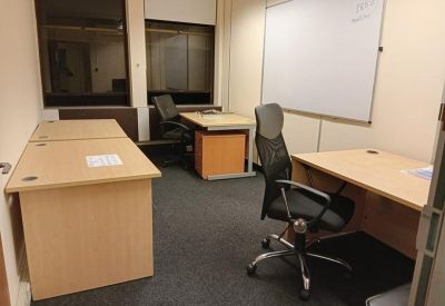 Private internal office suite with three desks and a large whiteboard.