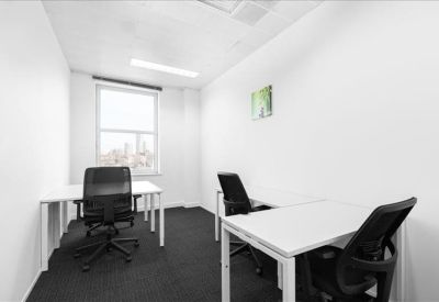 Private office suite with two white desks and black mesh chairs.