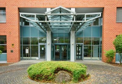 Main entrance featuring a modern glass and steel canopy structure.
