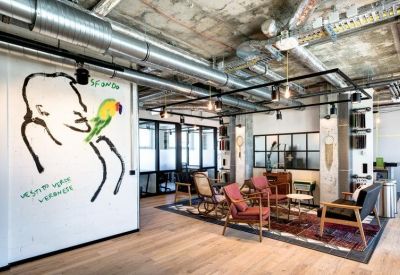 Meeting area with red armchairs and a creative line-art wall mural.