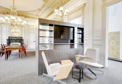 Elegant breakout area featuring a large television partition and classic architectural details.