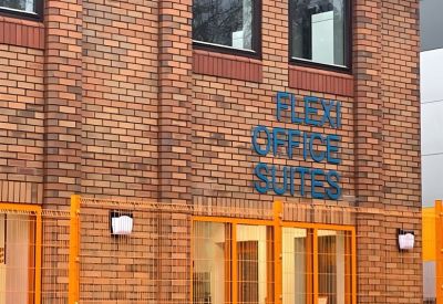 Exterior brick facade featuring blue Flexi Office Suites signage.