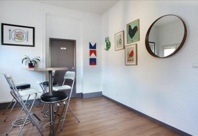 Breakout area with high chairs, round table, and artistic wall decor.