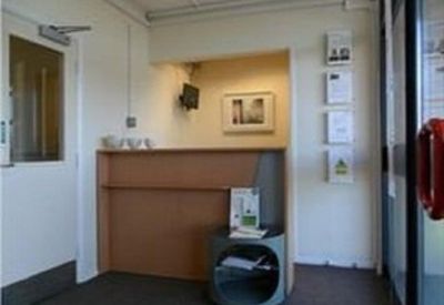 Reception area featuring a wooden front desk and informational wall displays.