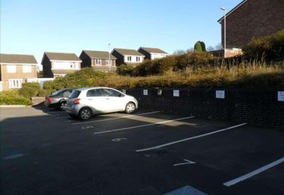 On-site parking area with designated spaces in front of residential buildings.