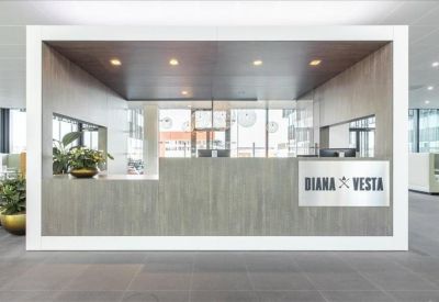 Modern reception desk with wood paneling and Diana & Vesta branding.
