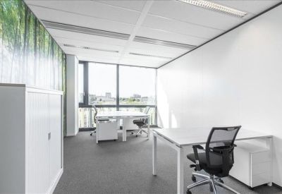 Private office suite with white desks and a nature-themed feature wall.