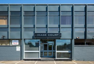 Exterior view of the blue-grey facade and glass entrance of Image House, 326 Molesey Road.