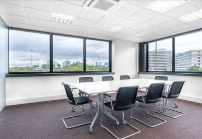 Professional meeting room with a large white table and city views.