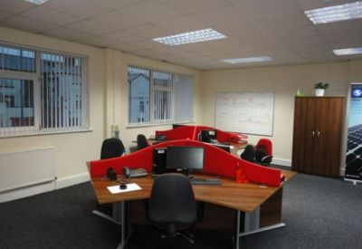 Office suite with modern workstations and red privacy dividers.