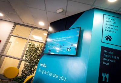 Modern branded feature wall with an information screen and turquoise accents.