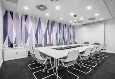 Sleek white and wood reception desk in a brightly lit lobby.