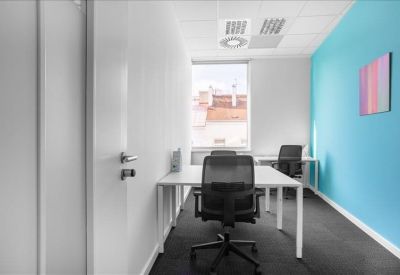 Private office suite featuring a blue accent wall and two workstations.