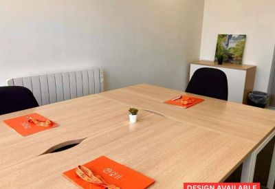 Meeting room with a wooden table and orange folders.