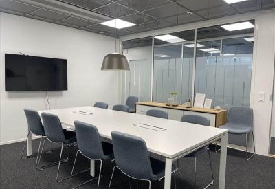 Clean, professional reception desk with wood accents and a frosted glass backdrop.