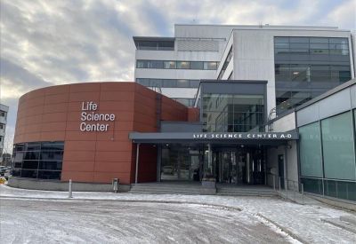 Private two-person office suite with ergonomic chairs and a window view.
