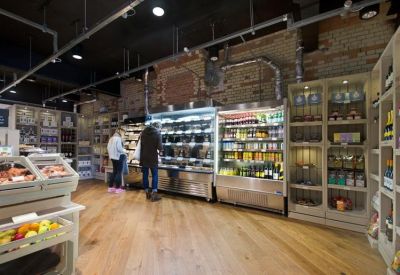 Interior pantry and retail area with exposed brick walls and refrigerated displays.