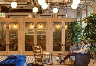 Private phone booths with glass doors and comfortable seating nearby.