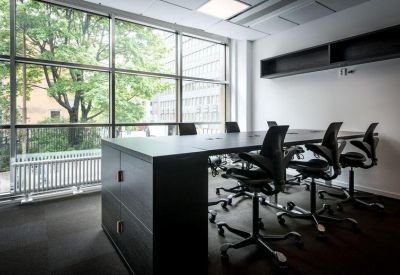 Contemporary meeting room with high-back chairs and large floor-to-ceiling windows.