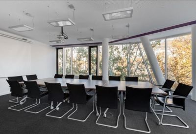 Large professional boardroom with a long table and seating for fourteen people.