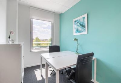 Private office featuring a teal accent wall and white desk.