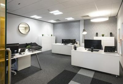 Private office suite with white desks and minimalist furniture.