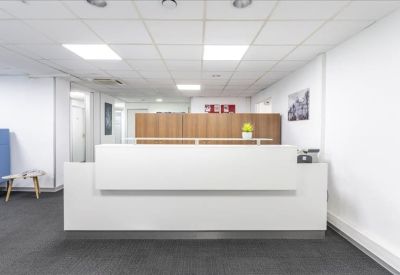 Sleek white reception desk in a brightly lit lobby area.
